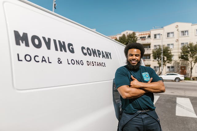 Professional mover standing next to a white van