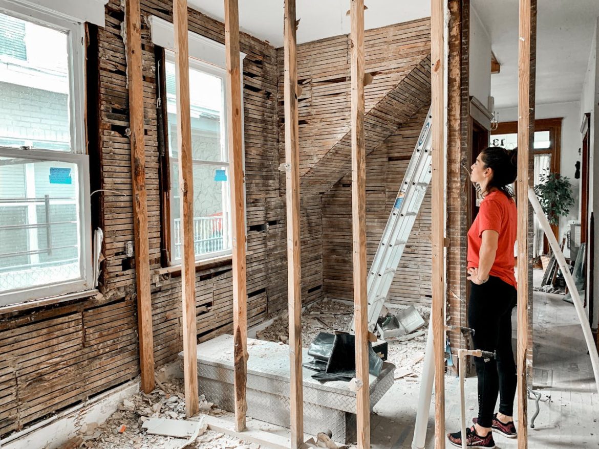 Woman standing in a room with unfinished walls